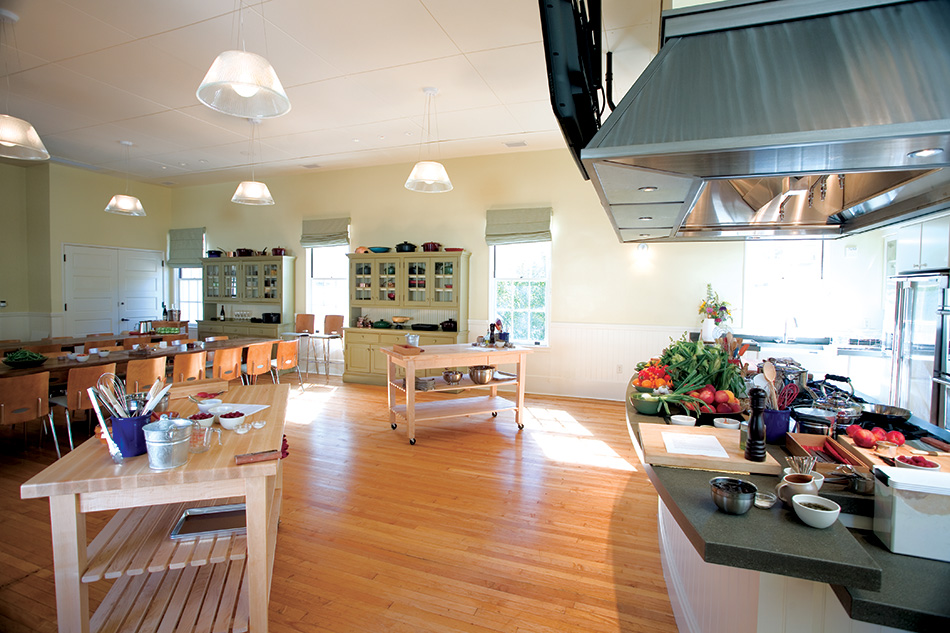 Fort Baker Retreat Group Cavallo Point Lodge & Spa, Sausalito, CA: Hospitality renovation and new construction by Herrero Builders in a historic landmark, with Leddy Maytum Stacy Architectural Resources Group. Interior view of a teaching kitchen with butcher-block islands and a range hood.
