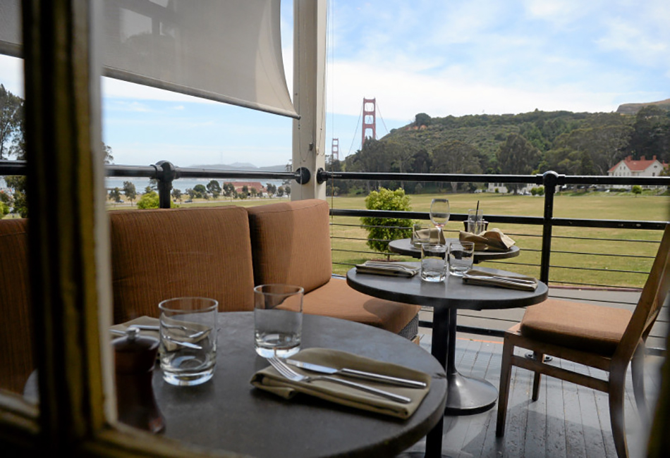 Fort Baker Retreat Group Murray Circle Restaurant, Sausalito, CA: Hospitality and Historic renovation and new construction by Herrero Builders, with Leddy Maytum Stacy Architects. Interior view of a terrace table setting with a view of the Golden Gate Bridge.