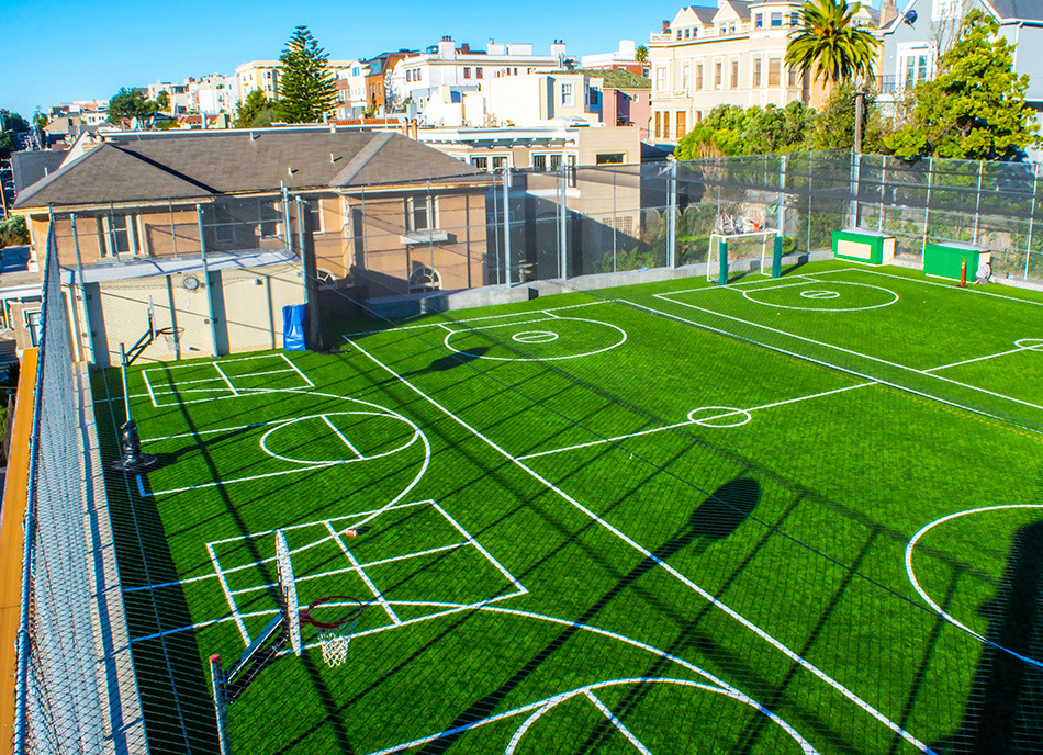 Town School for Boys Core Building & West Wing Excavation, San Francisco, CA: Education New Construction by Herrero Builders with significant excavation on an occupied campus, with MKThink. Site view of a synthetic turf play field with court markings, goals and surrounding rooftops.