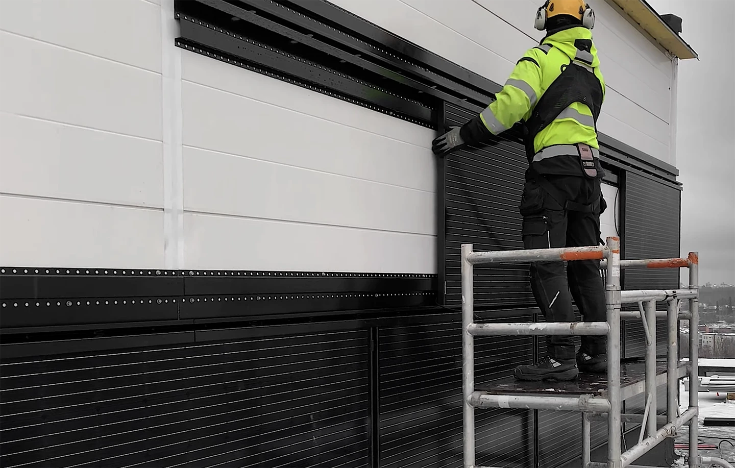 Man installing rauli wall on warehouse using easyslide system