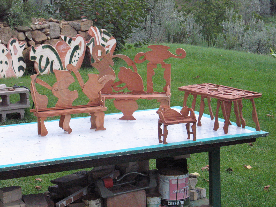 All images related to Betty Woodman’s “Bronze Bench #3,” 2003. 57 x 62 x 16 in. Bronze, patina. From L to R: clay models for bronze benches outside Betty’s studio in Antella, Italy / Benches in progress at the Fonderia with Betty’s full-scale drawing / Applying the patina according to Betty’s drawing / The finished bench arrives at Betty’s studio in Antella / Installation view in the courtyard of the Palazzo Pitti, Museo delle Porcellane, Florence, Italy, 2010 / Installation view, “Betty Woodman: In the Garden,” Greenwood Gardens, Short Hills, New Jersey, 2016 / Betty outside of her studio in Antella. Woodman Family Foundation Archives.