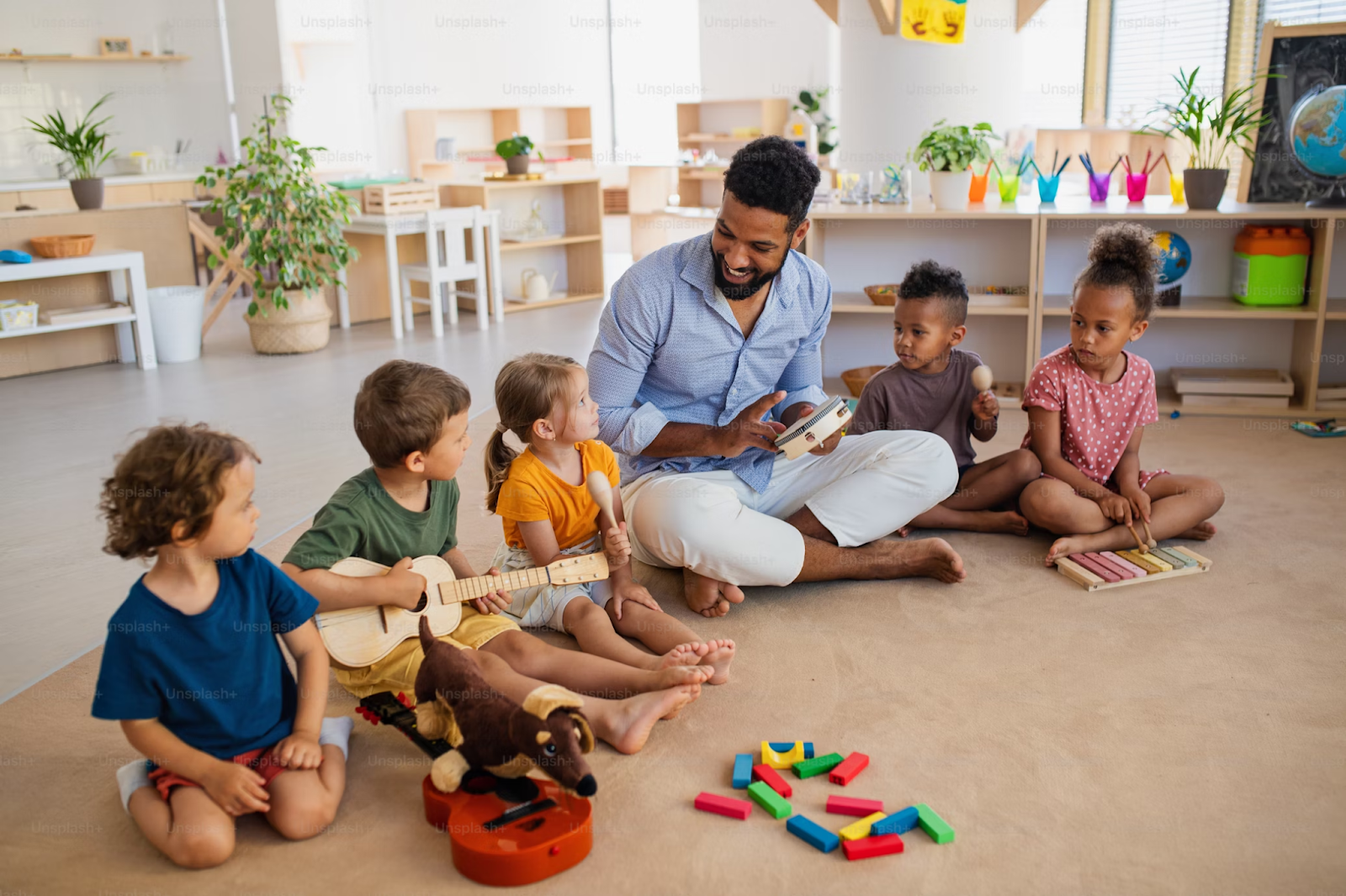 A diverse group of young children sitting in a music circle, each with an instrument smiling, focused, and engaged in playful interaction.