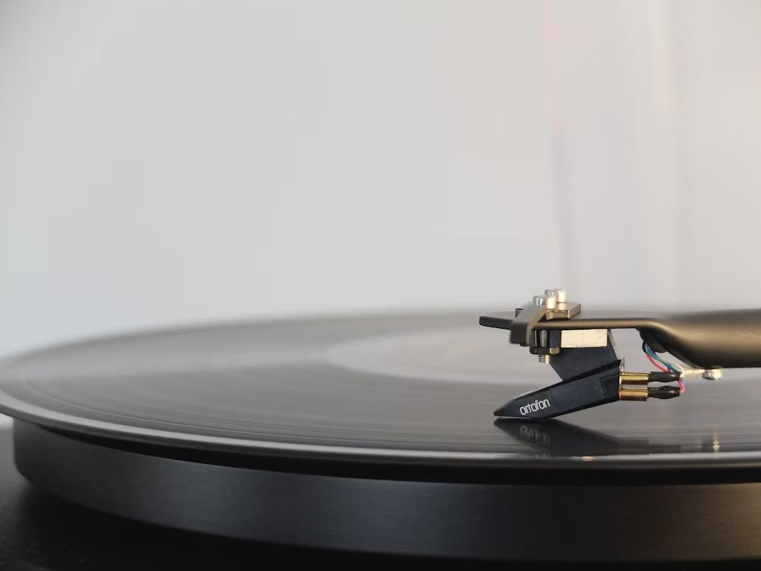 Black vinyl disc on a vinyl player.