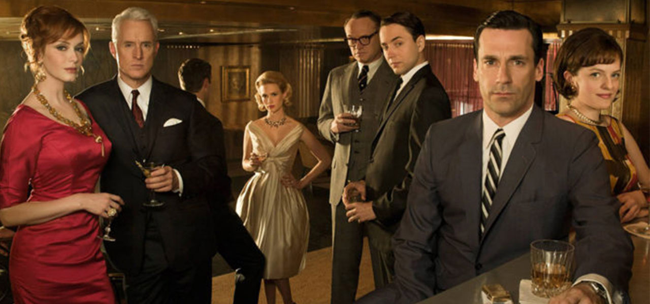 Cast of Mad Men holding cocktails.
