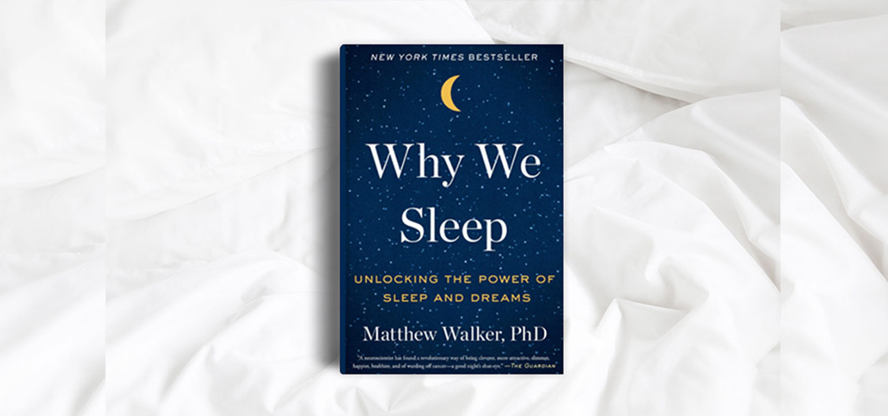 Why We Sleep book cover on white sheets.