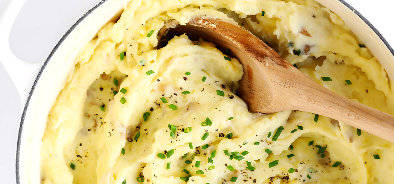 Close up image of mashed potatoes with chives and potato skin.