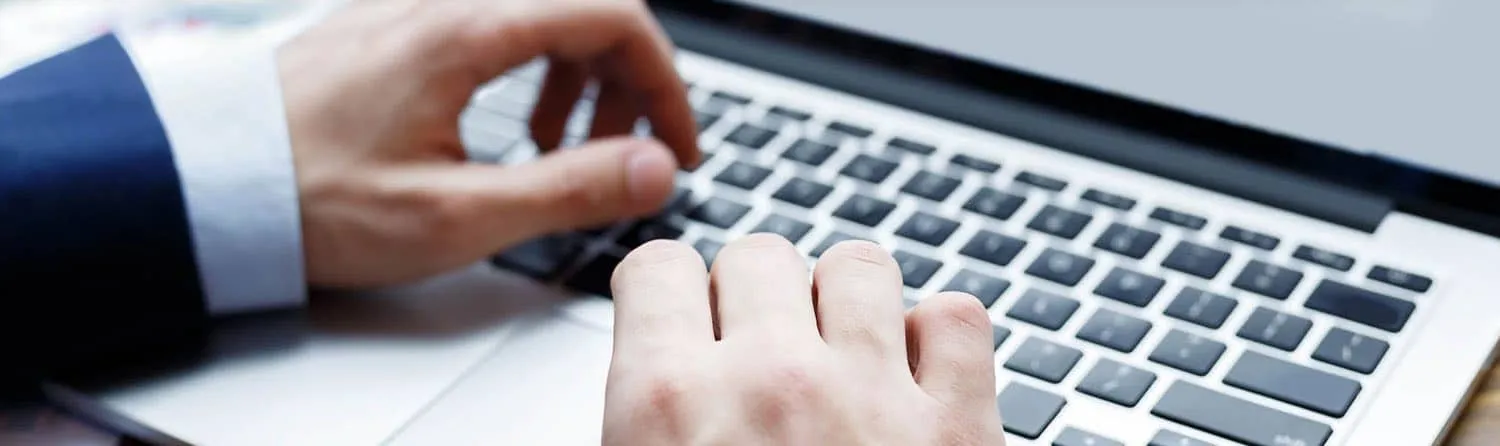 person typing in keyboard