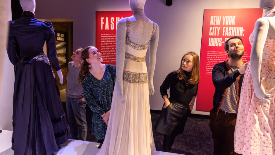 The museum section of RiseNY, people admiring costume and fashion pieces displayed at the exhibit