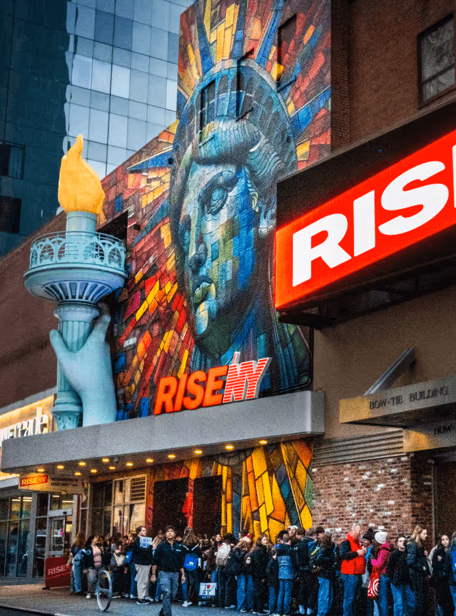 The outside of RiseNY showcasing the mural of the Statue of Liberty 