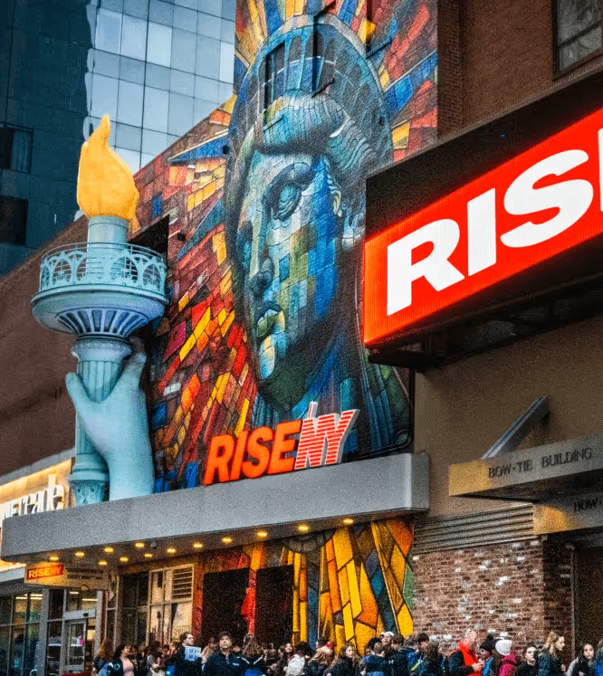 The outside of RiseNY showcasing the mural of the Statue of Liberty