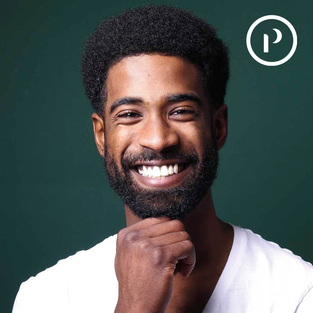 Platineers Smile. Young man smiling on green background.