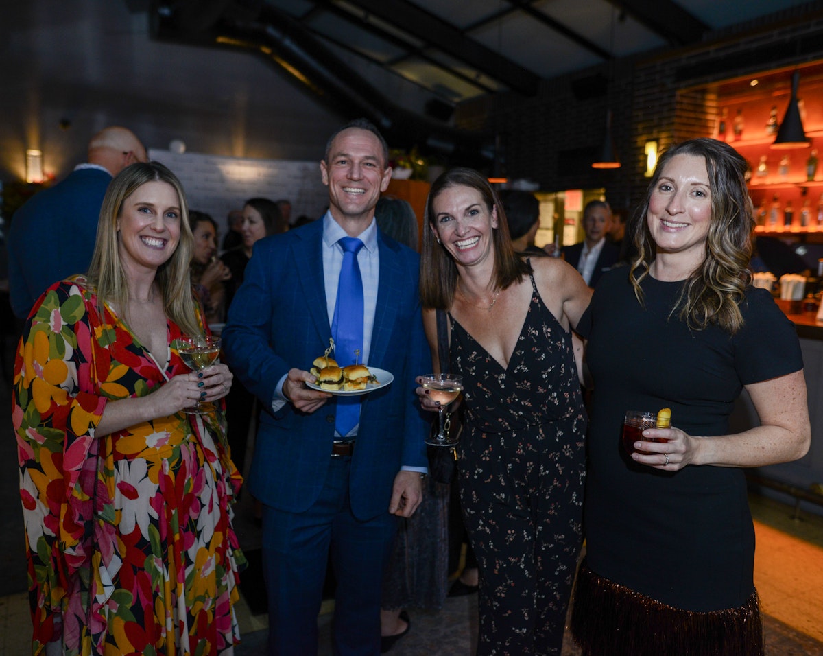 Group of guests mingling with cocktails and small bites during cocktail hour at The Adventure Project 15th Anniversary Gala.