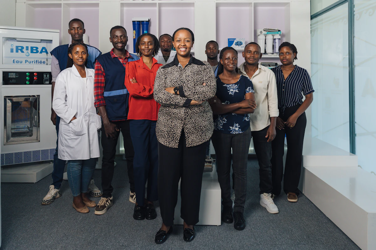 Yvette stands with members of the Iriba Water Group team.