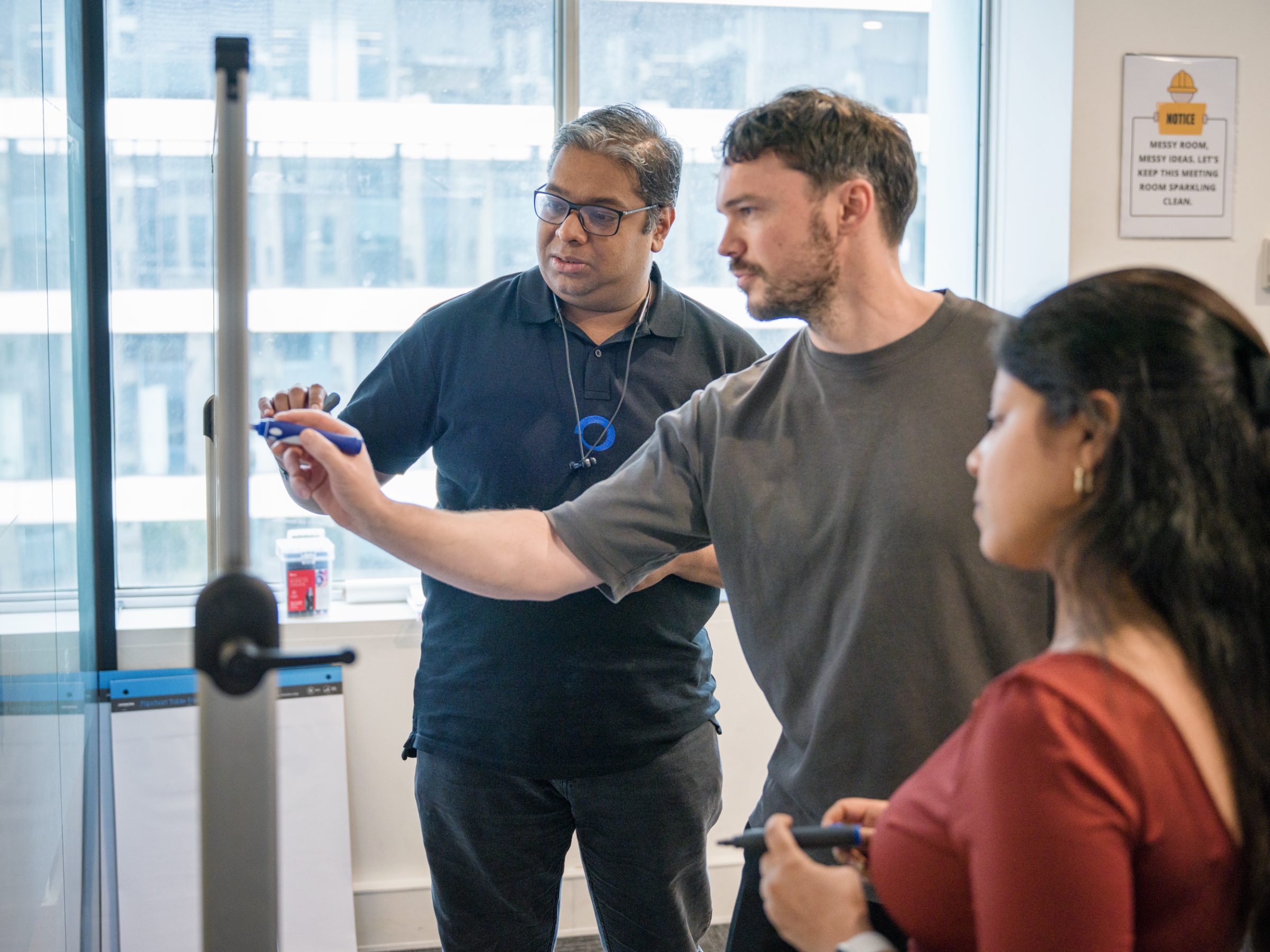 Fabric team working through a problem at the whiteboard