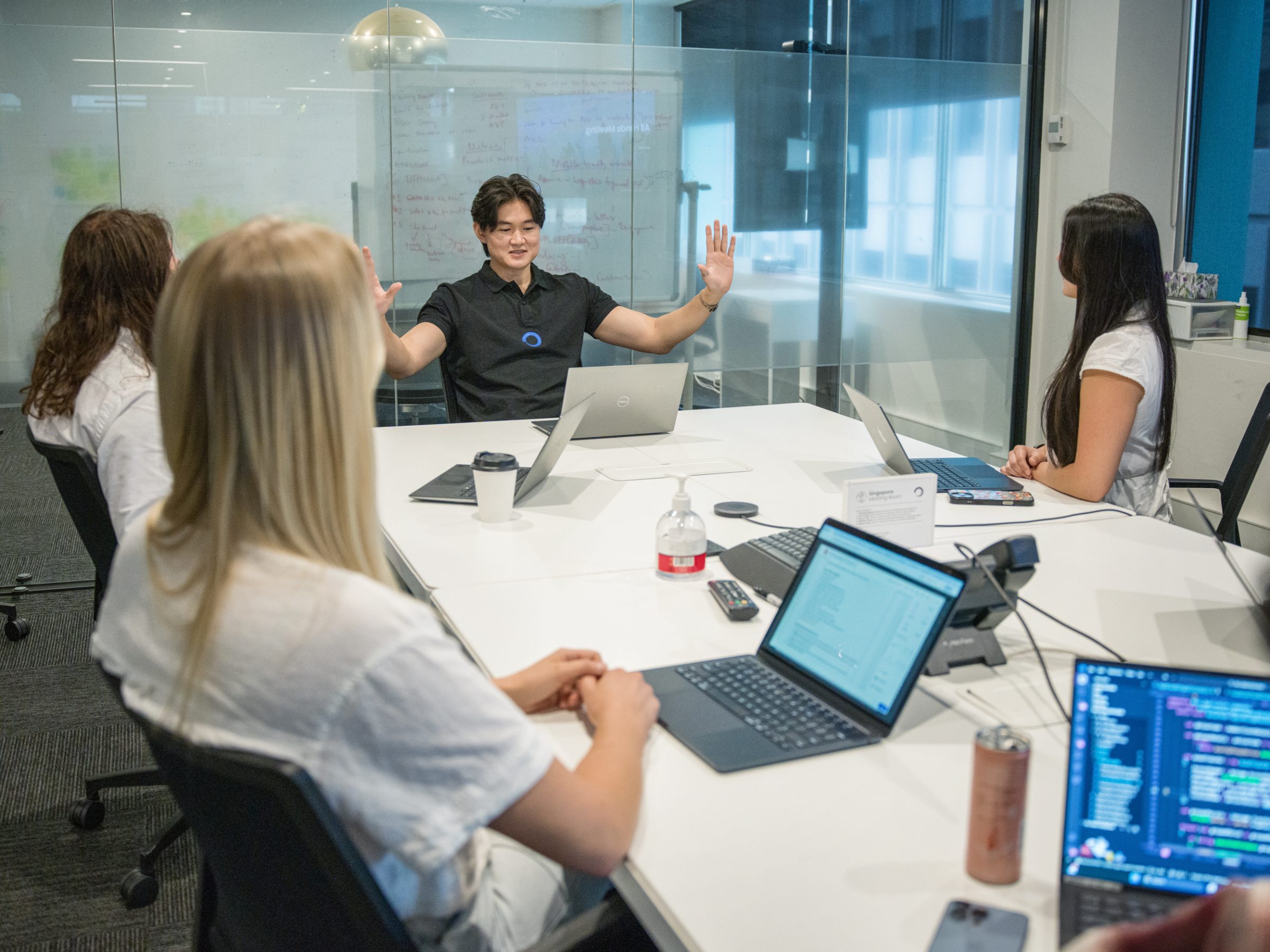 Four Fabric colleagues mid-discussion in a meeting room