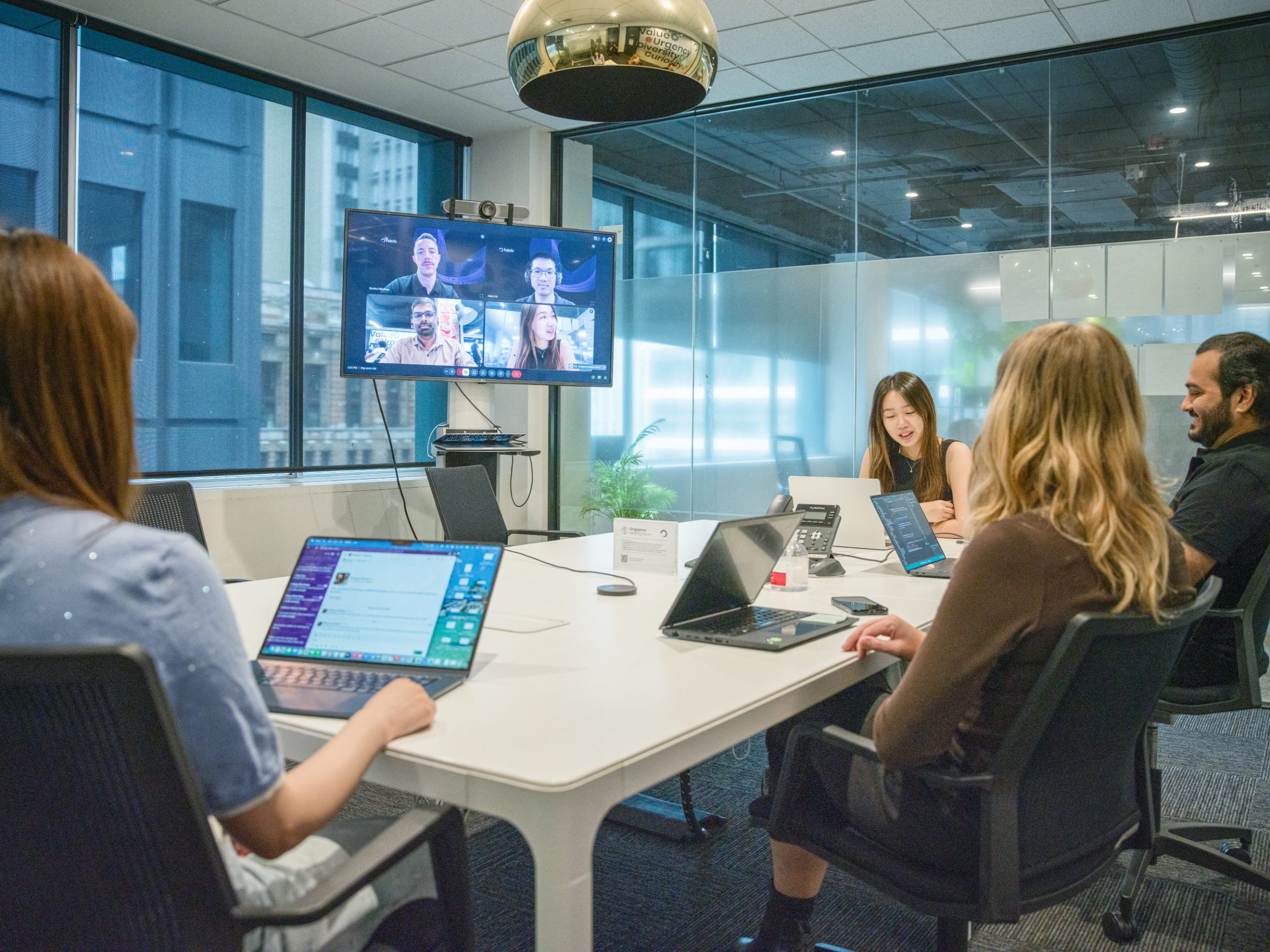 Fabric colleagues working together in the room and joining by video across APJ