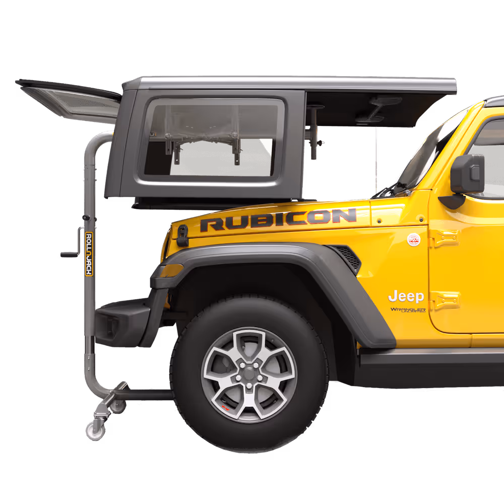 Yellow Jeep Rubicon with a gray rooftop tent partially extended over the rear section and supported by a Roll-N-Jack system.