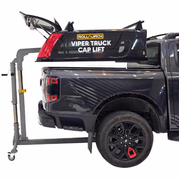 Black pickup truck with a lifted Roll n Jack Viper Truck Cap Lift holding a truck cap above the truck bed.