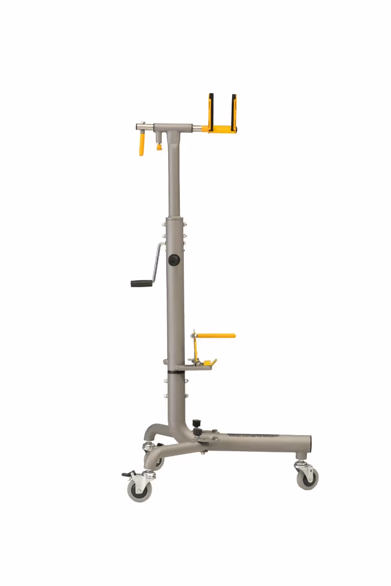 Metal bike repair stand with yellow clamps and hand crank on wheels for mobility.