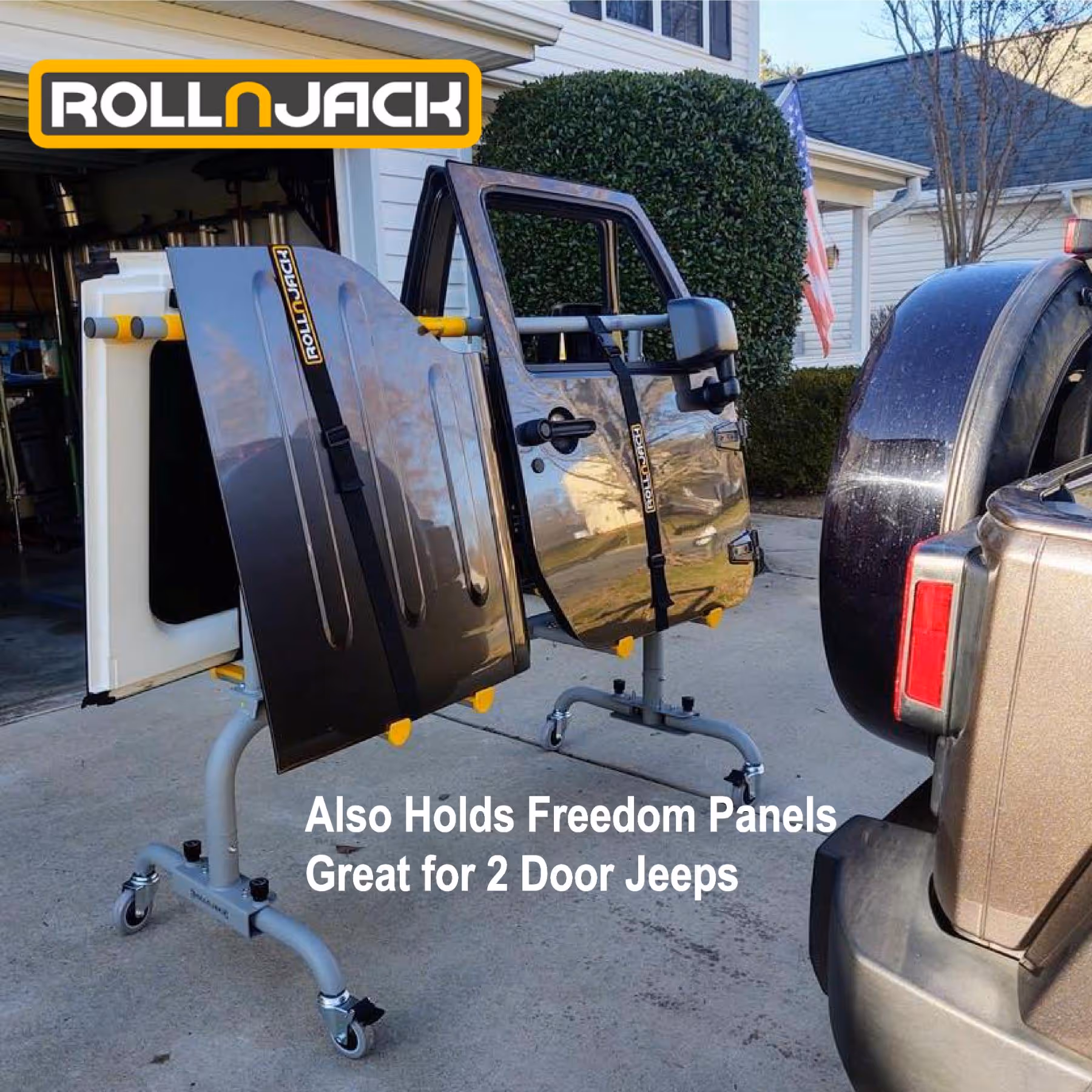 RollnJack Freedom Panels holder with two Jeep doors secured by straps, displayed outdoors near a Jeep vehicle.