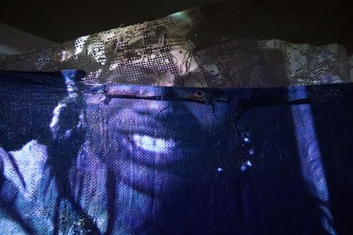 Scatty Blue Construction canvas. Warrior SQ, E12 Video projection and layered tarp. Photography by Jonny Tanna, images courtesy the artist and Harlesden High Street.