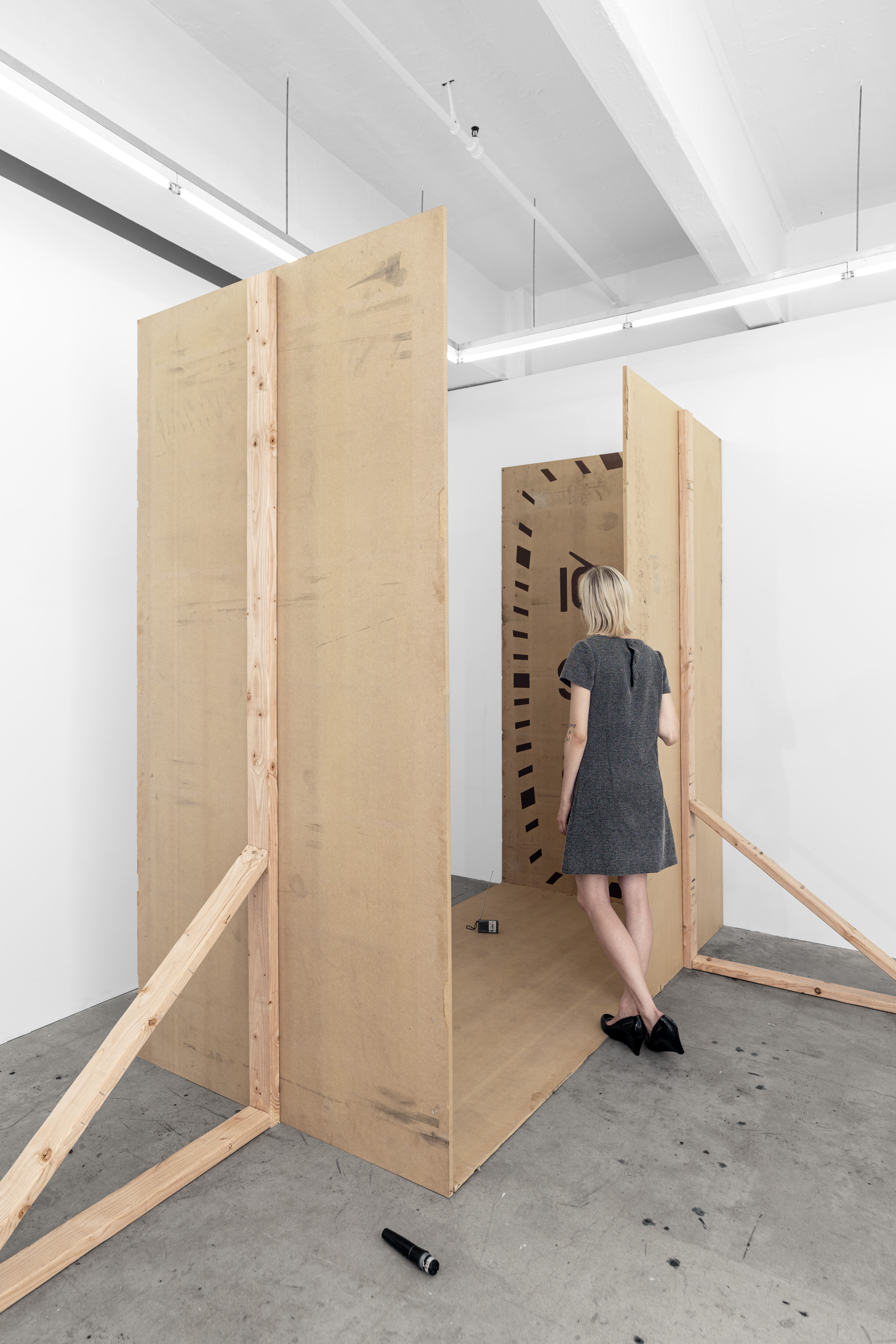 Stage, 2025 MDF board, wood, screws, marker, oil-based enamel, tape, headphones, table, DJ mixer, laptop, nails, microphone, folding table, bag, dress, radio, shoes, water, cables, hammer