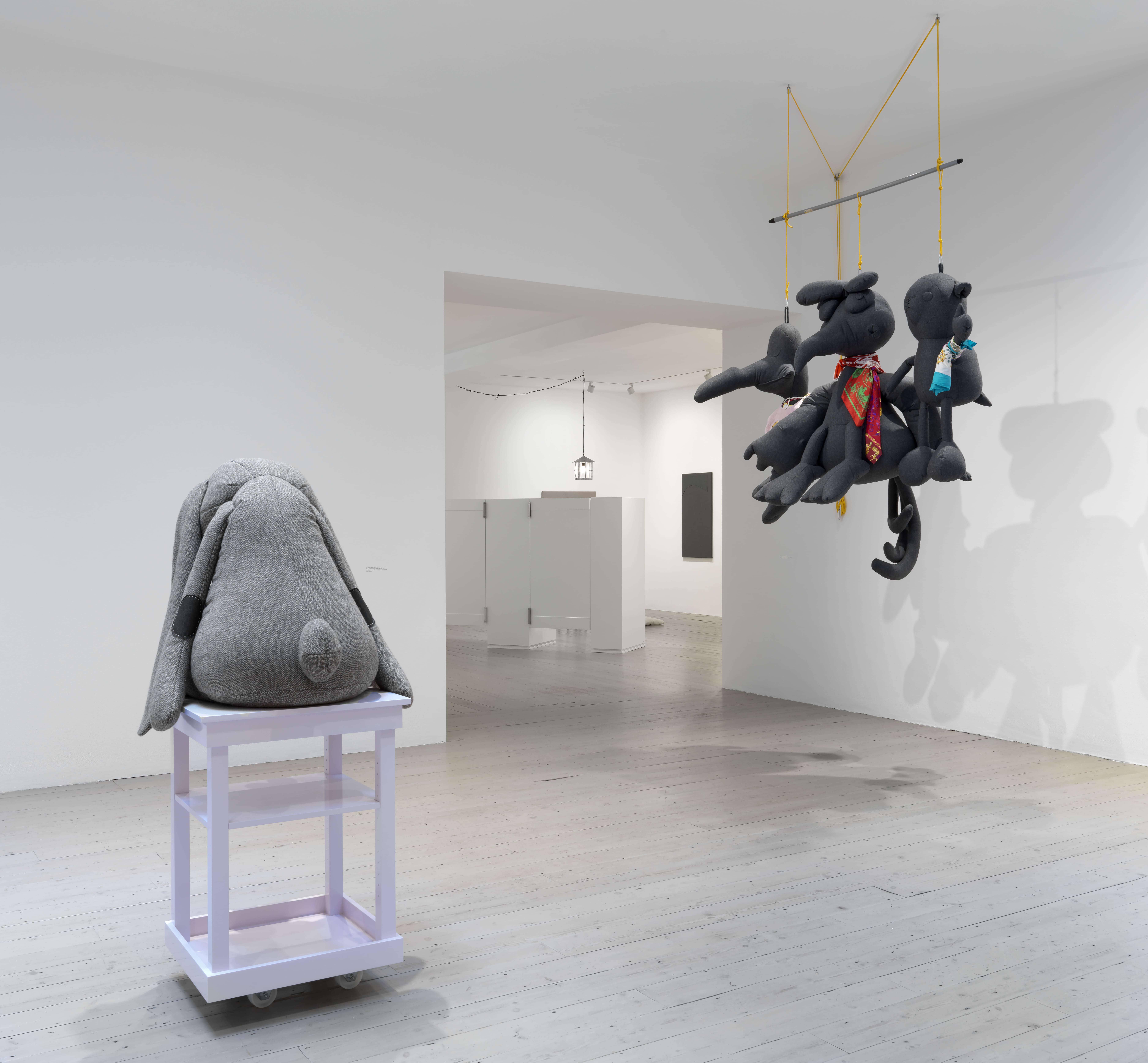 Foreground, from left to right: The Bonin/Oswald Empire’s Nothing #06 (CvB’s Exhausted Tweed Rabbit & Purple Crab On Pink Table), 2010, Private collection | Thrown Out of Drama School, 2008, Collection Beth Rudin DeWoody | Background: John James (Loop #2), 2004, Meyring Collection | Installation view, Cosima von Bonin: Upstairs Downstairs, Raven Row, 2025 Photograph by Marcus J Leith.
