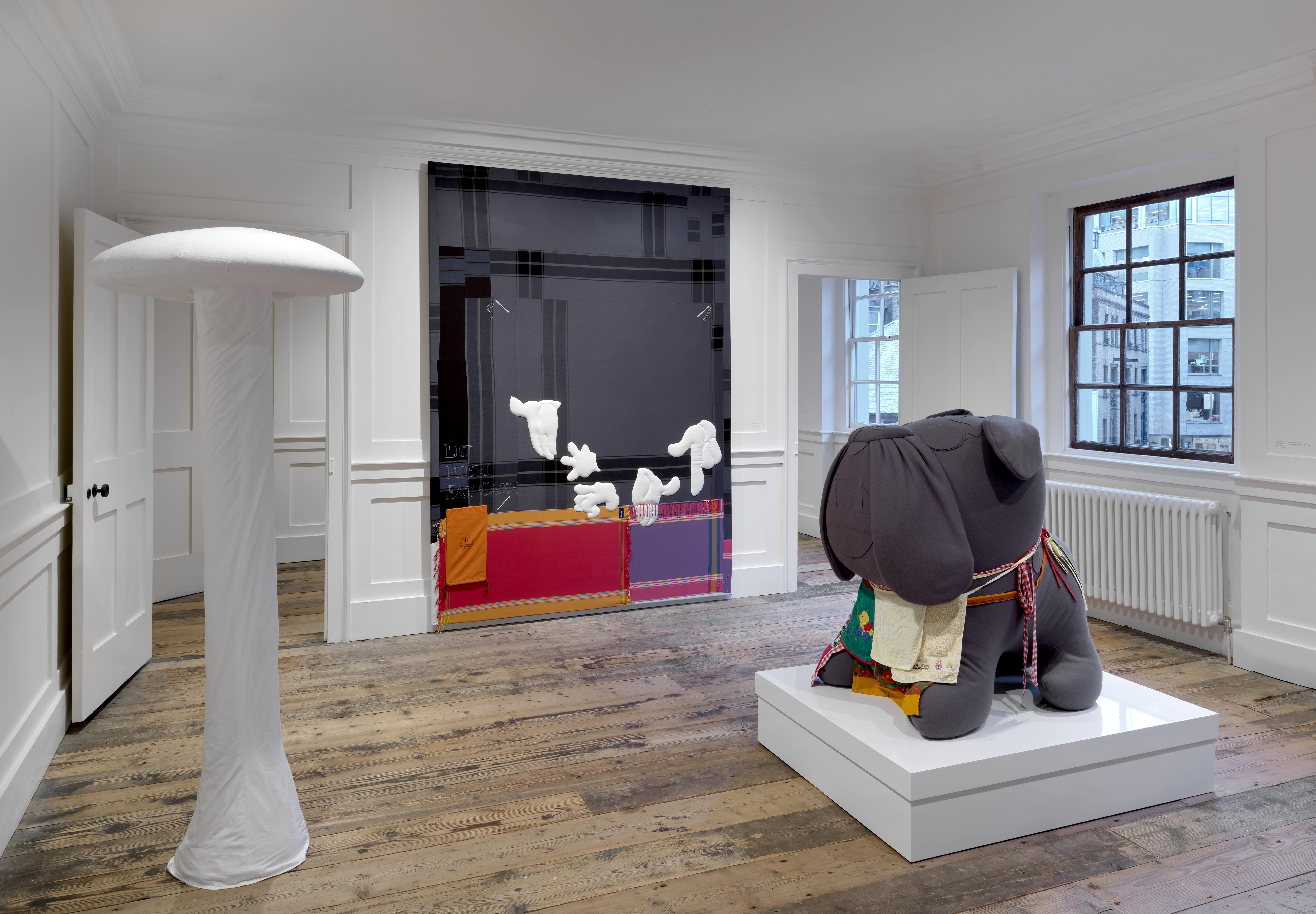 From left to right: Therapie (#61), 2002, Meyring Collection | Let Them Eat Cake, 2008, Private collection, Vienna | Untitled (The Grey Bulldog With Box & Aprons), 2006, Private collection | Installation view, Cosima von Bonin: Upstairs Downstairs, Raven Row, 2025 Photograph by Marcus J Leith