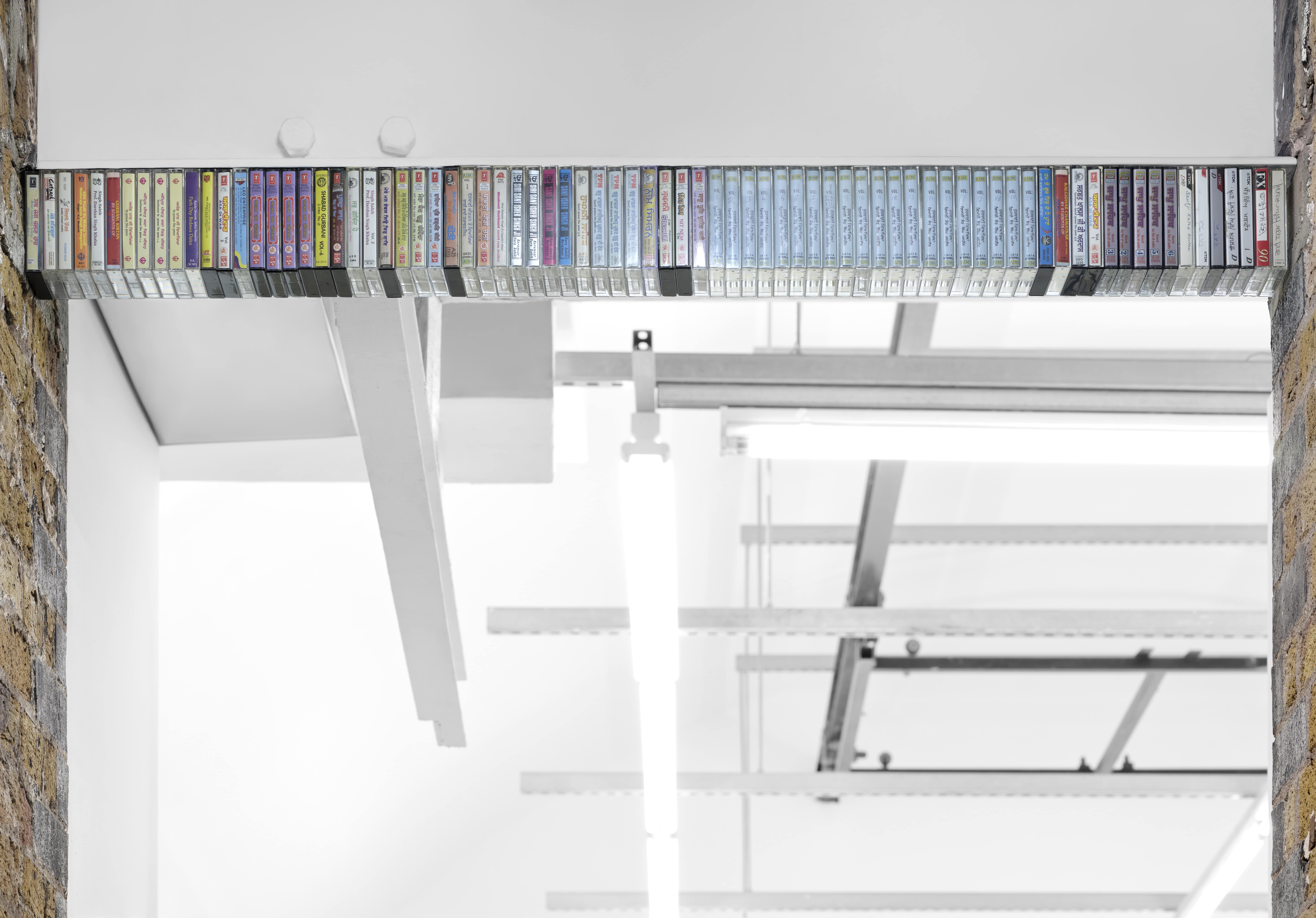 Jasleen Kaur, Keystone II, 2025, 79 cassettes, magnets, 10.2 x 6.35 x 1.27 cm (each cassette) 10.2 x 134 x 6.35 cm (overall). Courtesy the artist and Hollybush Gardens, London. Photo: Eva Herzog