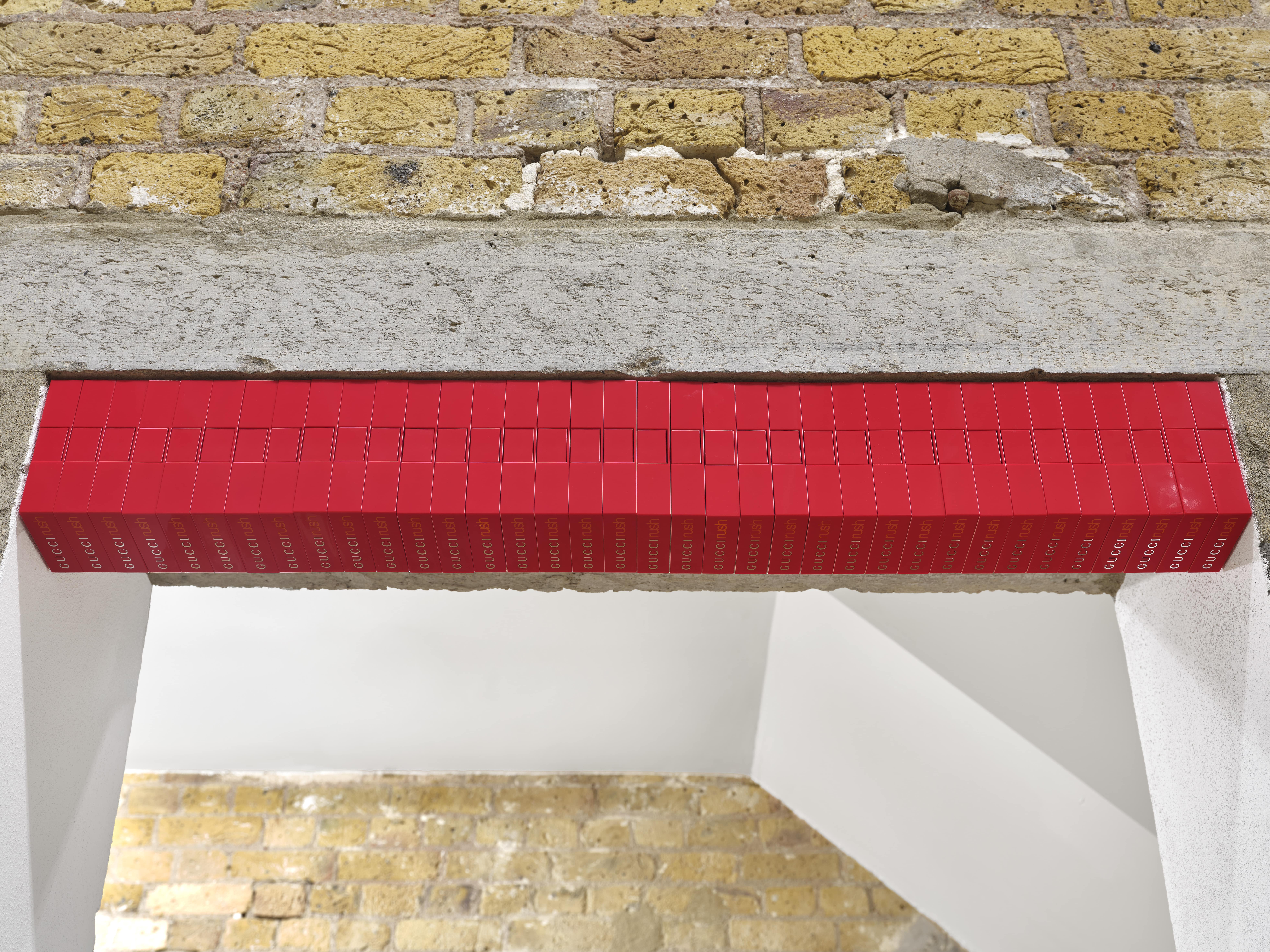 Jasleen Kaur, Keystone I, 2025, 36 Gucci Rush, magnets, 11.8 x 8.4 x 2.5 cm (each) 11.8 x 88 x 8.4 cm (overall). Courtesy the artist and Hollybush Gardens, London. Photo: Eva Herzog