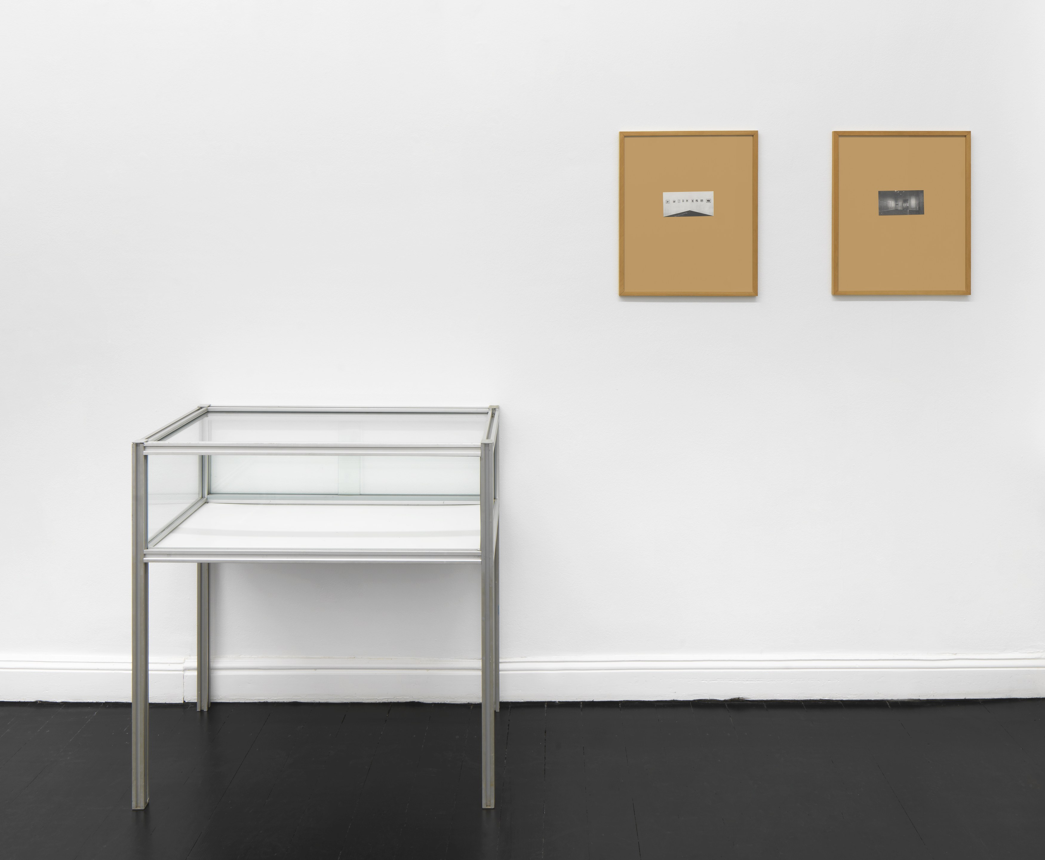 Michael Krebber, Untitled, 1989, 2 photocopies mounted to card and framed (each 49 × 40.7 cm), 1 empty vitrine (90.7 × 90 × 47 cm), 3 black-and-white photographs (each 23.8 × 30.3 cm), MK/I 1989/01_10. Courtesy of the artist and Galerie Buchholz.