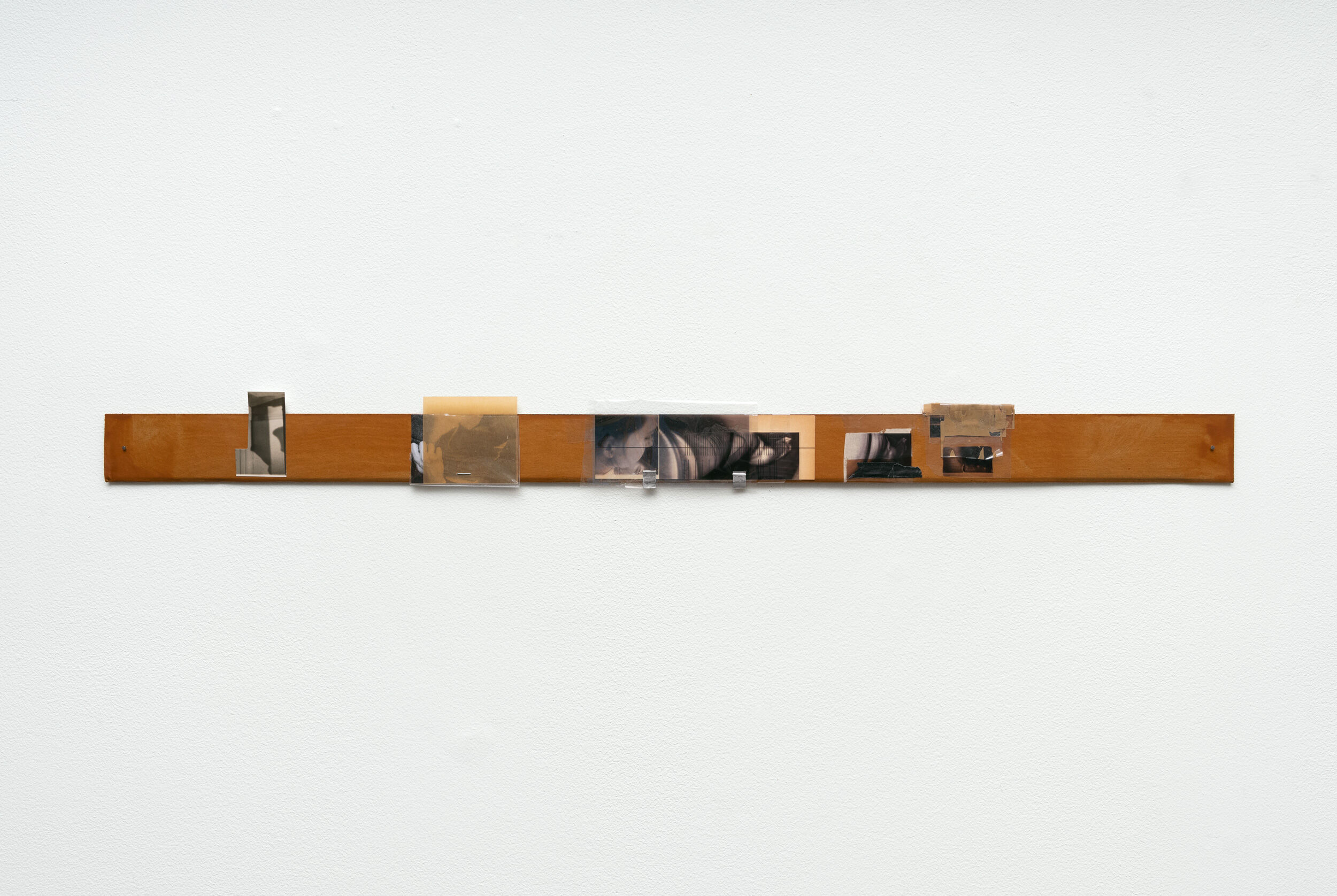 B. Ingrid Olson, Psychos Reservoir (Video Strip Contents I), 2012–2025, paper, plastic sheet, laser print, inkjet print, aluminum tape, chipboard, nails, 89 × 6.4 × 6 cm. Courtesy of the artist and Croy Nielsen.