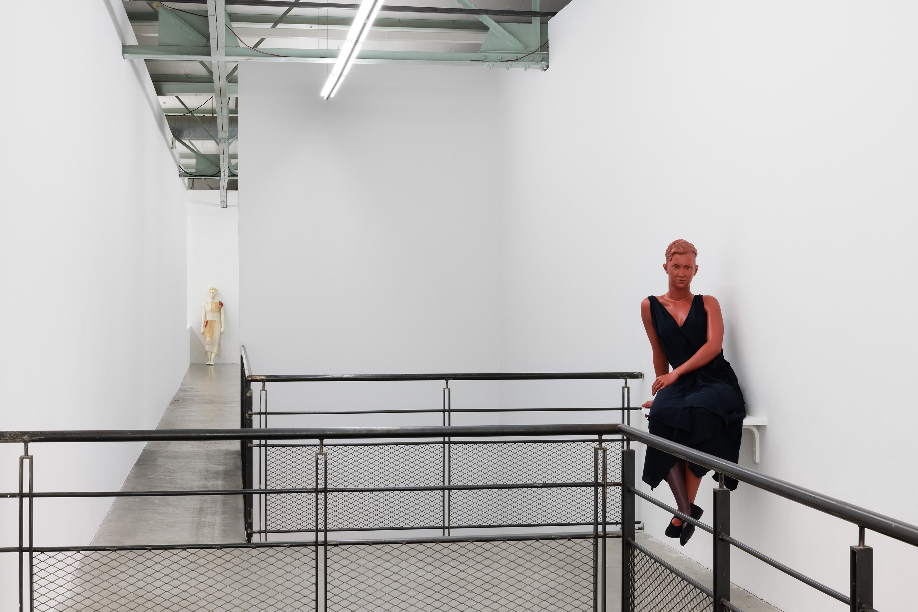 Installation view, Lucy McKenzie: Plastic Newspaper (2026), Crac Occitanie, Sète. Sitting Mannequin (Greek pottery / Quatre mouchoirs), 2020. Fibreglass, acrylic and oil paint, belted silk dress, sports shoes, shelf, 145 × 85 × 67 cm. Courtesy of the artist and Galerie Buchholz, Berlin / Cologne / New York. Photo: Useful Art Services.