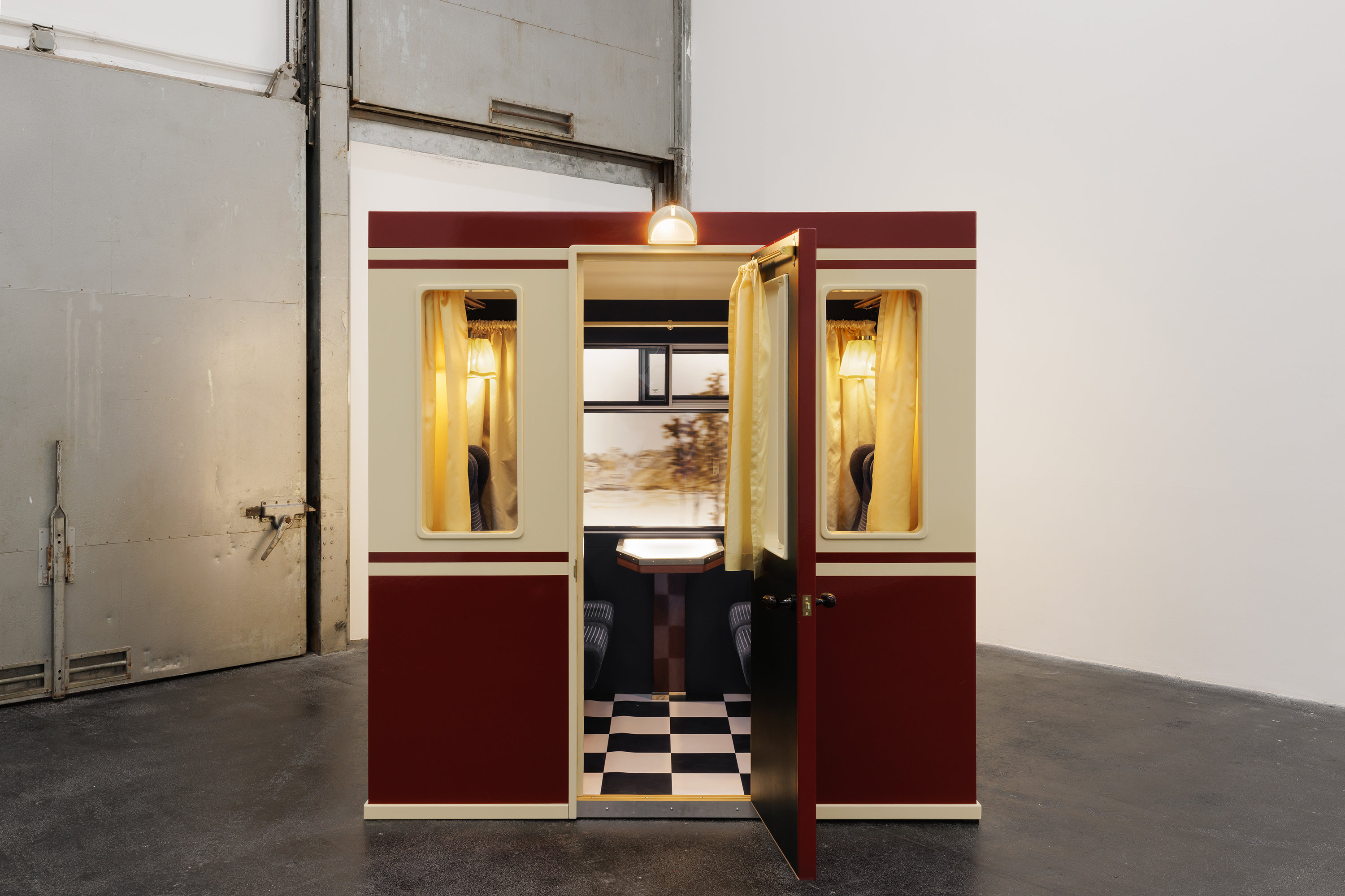 Installation view, Lucy McKenzie: Plastic Newspaper (2026), Crac Occitanie, Sète. Kaertner Bar Panorama Train – interior: front part and back part, 2024. Wood and metal structures, train furniture, glass, textile, motor, acrylic and oil on canvases, 200 × 220 × 120 cm for the train carriage, 150 cm diameter for the panoramic drum. Courtesy of the artist, Galerie Buchholz, Berlin / Cologne / New York. Photo: Useful Art Services.