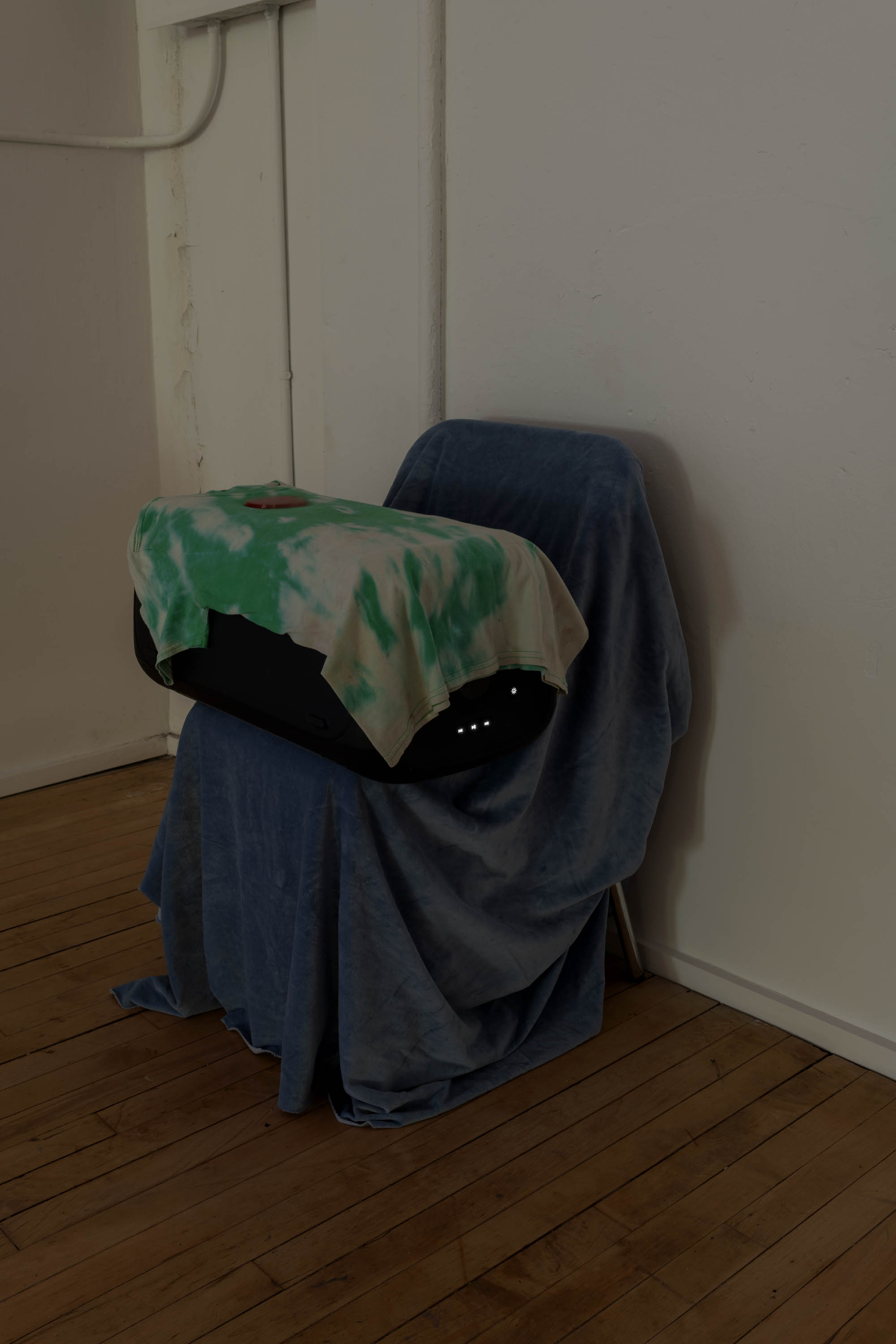 Michael E. Smith, Untitled, 2026, Speaker, .wav file, velvet, t-shirt, reflector, chair 32 × 24 × 20 inches (81.28 × 60.96 × 50.80 cm). Courtesy of the artist and Maxwell Graham, New York.