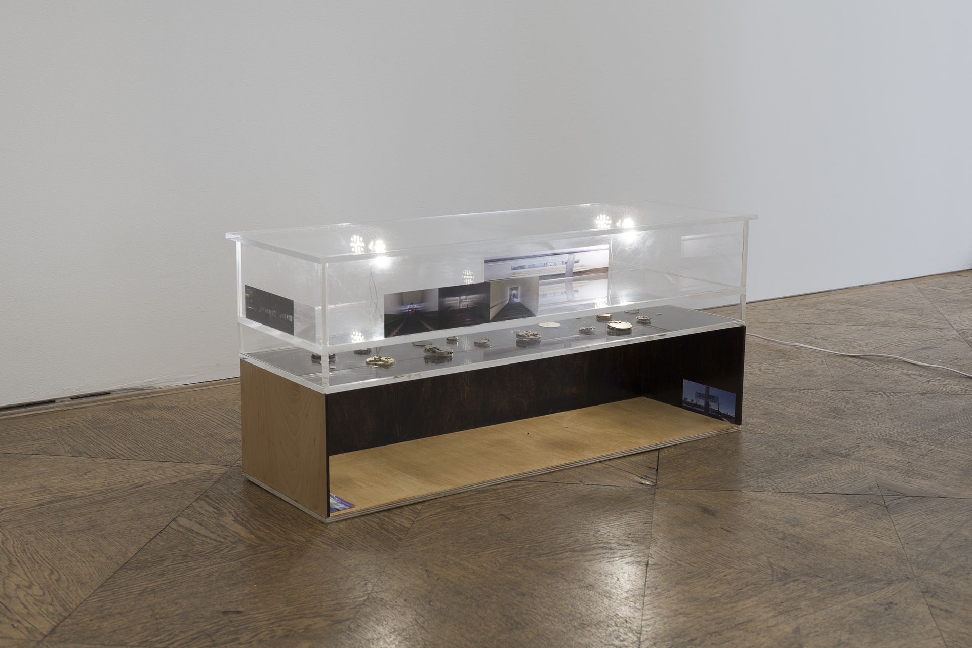 Hélène Yamba-Guimbi, my inheritance, 2026 Acrylic sheets, birch plywood, clock movements, fixture, lambda prints, 80×25×34 cm. Courtesy of the artist and Schiefe Zähne.