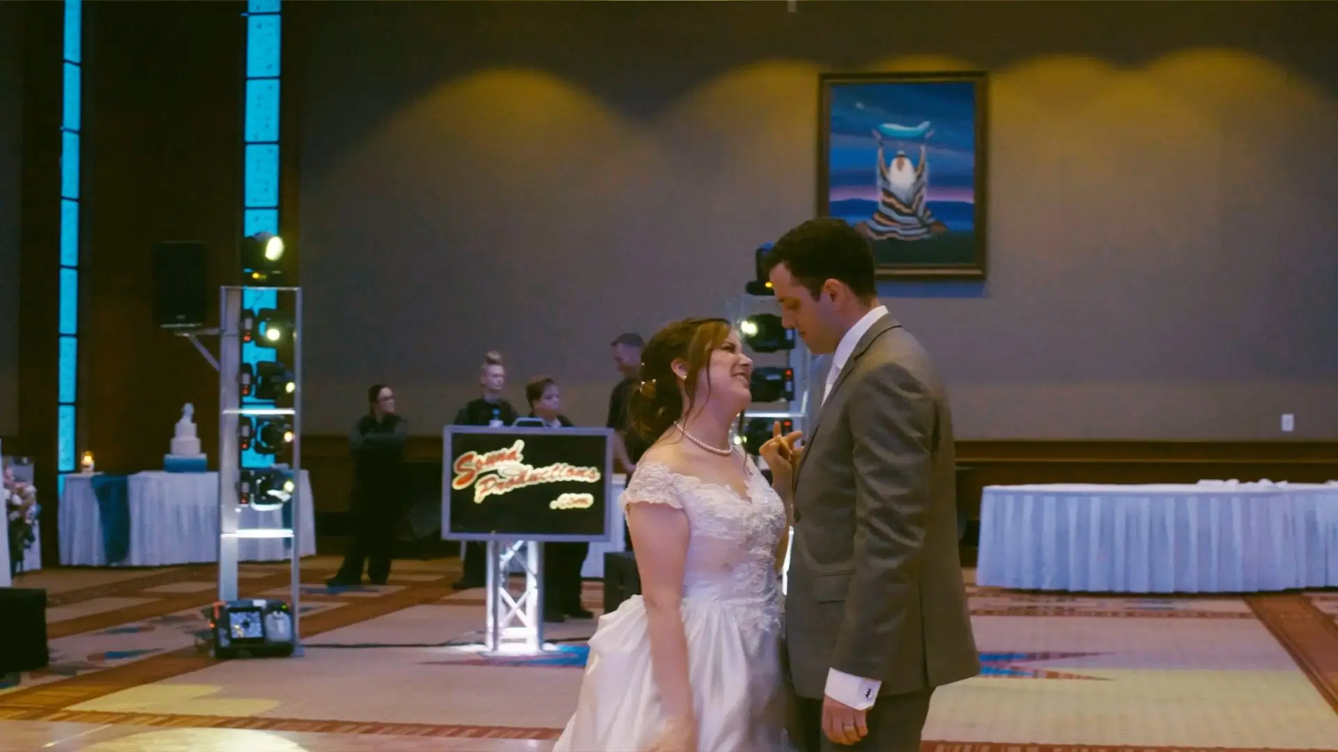 In this still from their wedding video, Elizabeth and Aaron share a dance during their reception at Soaring Eagle Casino. The DJ booth for Sound Productions is visible in the background.