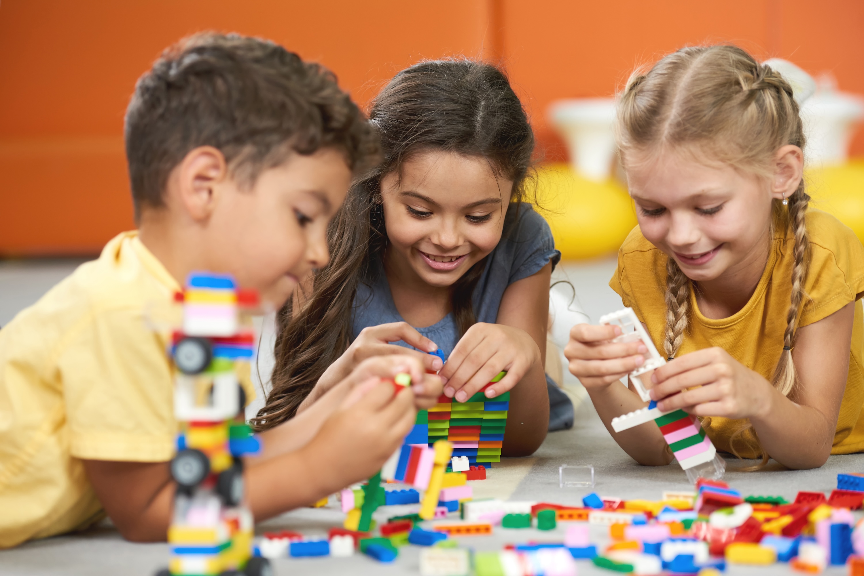 a group of kids playing with Legos as a fun activity in Houston