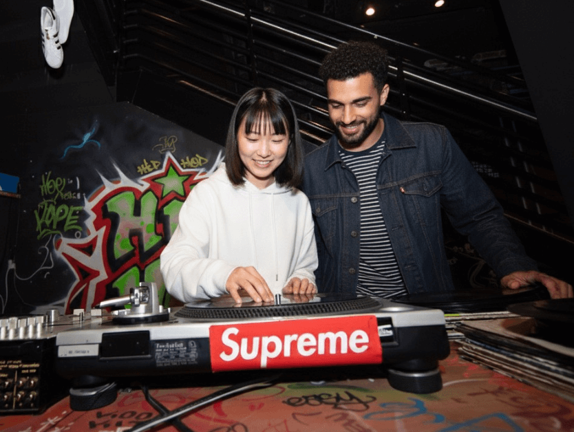 A couple mixing on a DJ deck at RiseNY