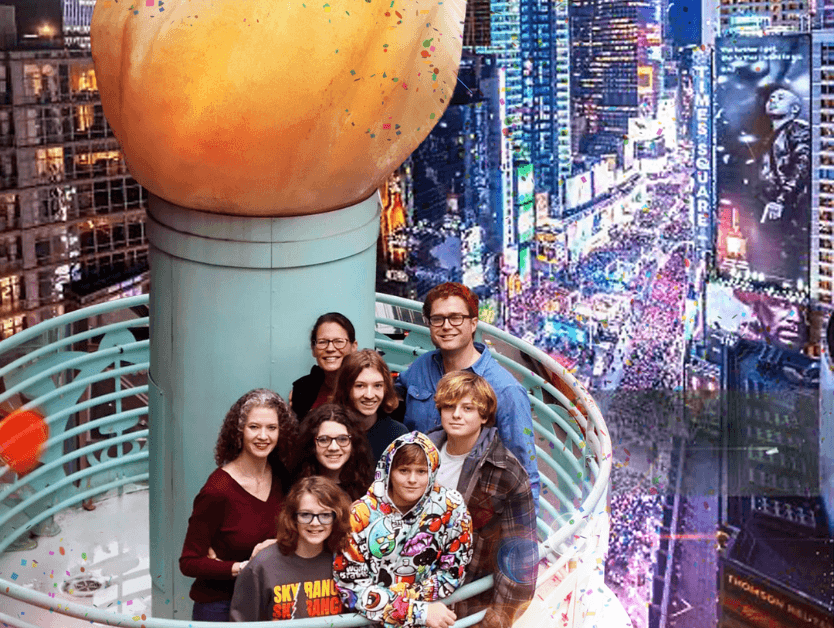 A family posing on the torch at RiseNY