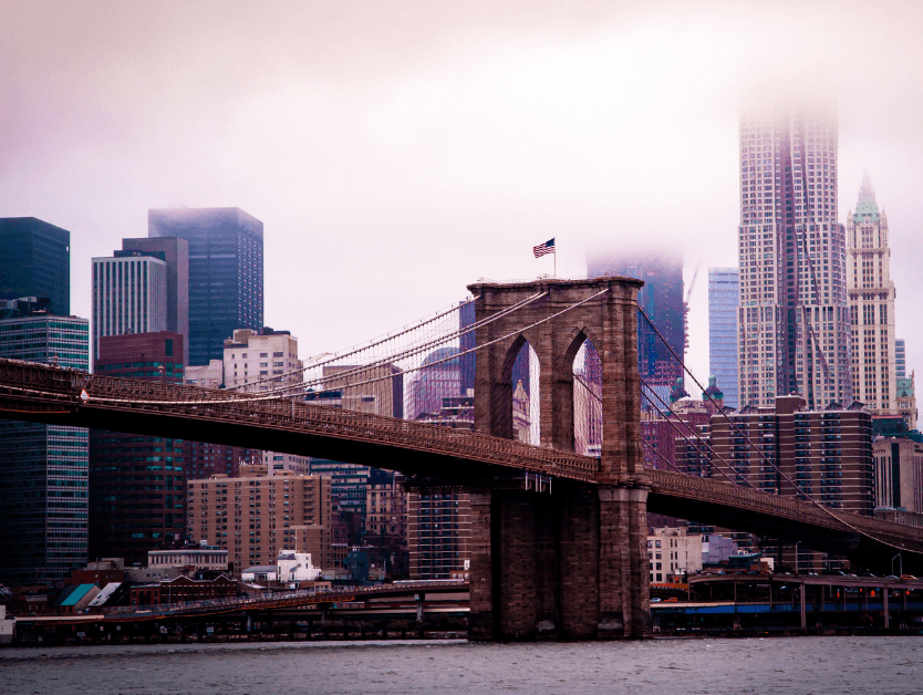 A foggy day in New York, the shot shows the Brooklyn Bridge