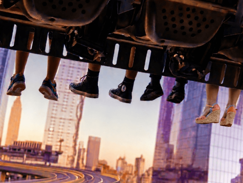 An image of feet dangling at the bottom of the RiseNY attraction as people ride the attraction