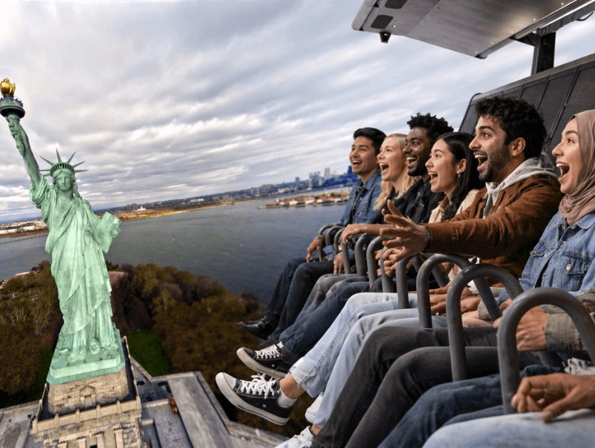 A group of people smiling and enjoying the ride portion of RiseNY