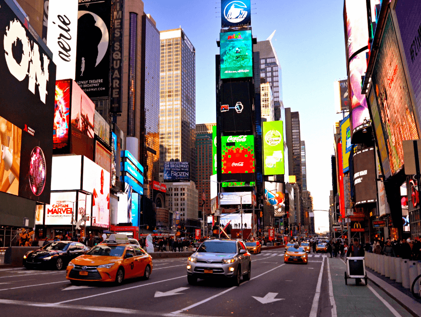 A photo of the center of Times Square at just before sunset