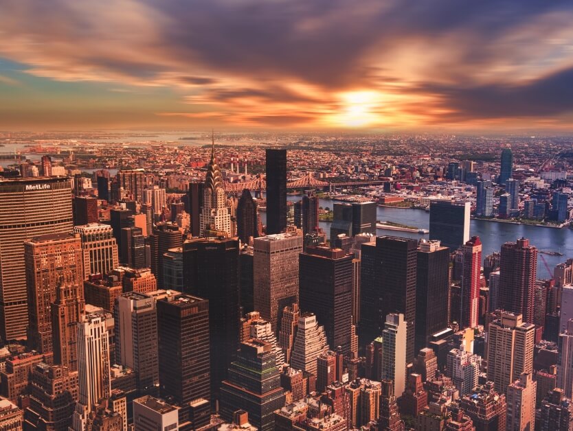 A skyline image of New York City at sunset