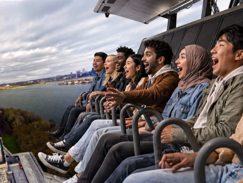 A group of young adults riding the RiseNY attraction