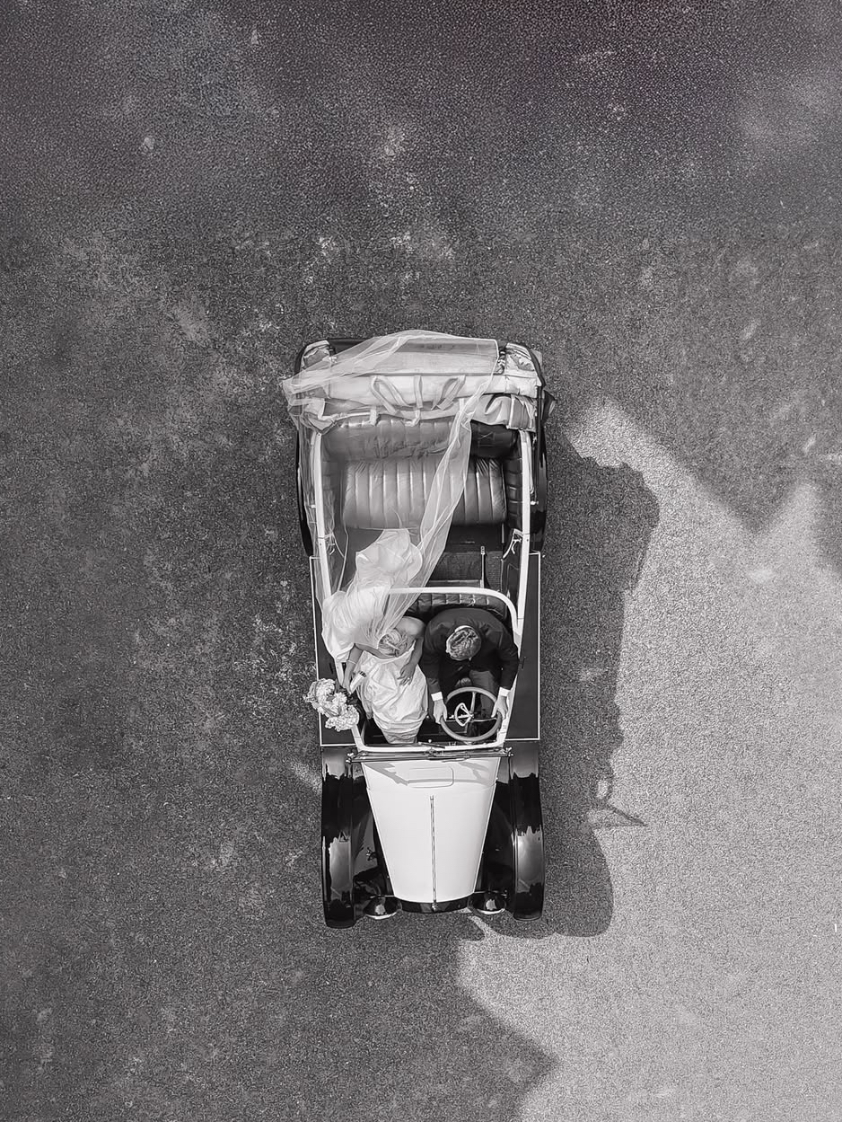 1924 Studebaker Convertible parked outside One Pelham East in Newport RI – vintage wedding rental and classic car tour vehicle with whitewall tires and wooden spokes.