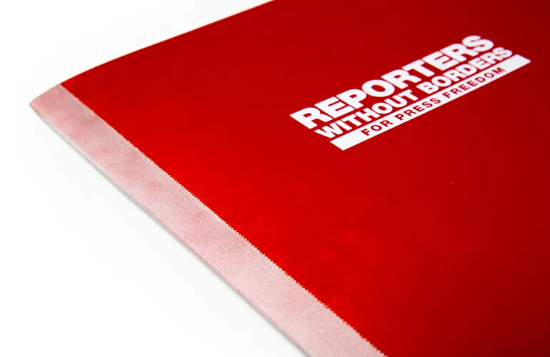 Folio contents held together with press passes