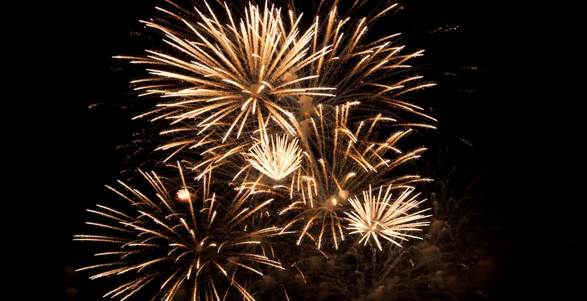 An image of gold fireworks at night