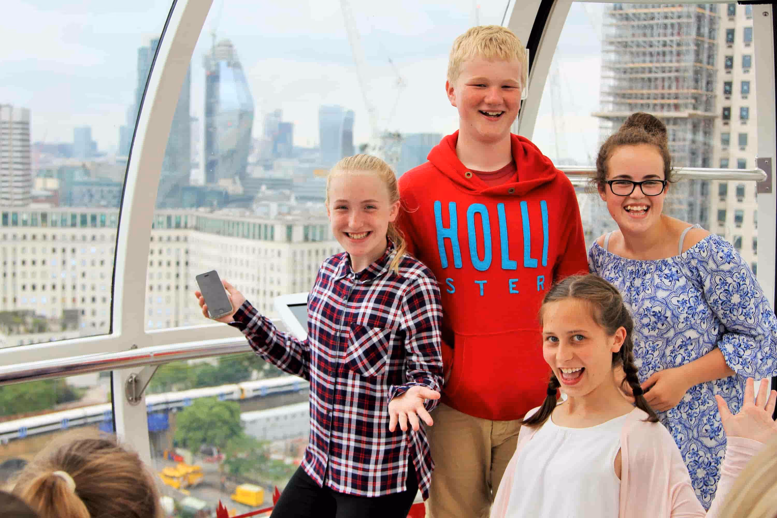 A group of four happy, young students having fun at a school trip